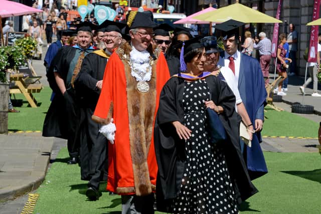 Tutors proudly march through the town