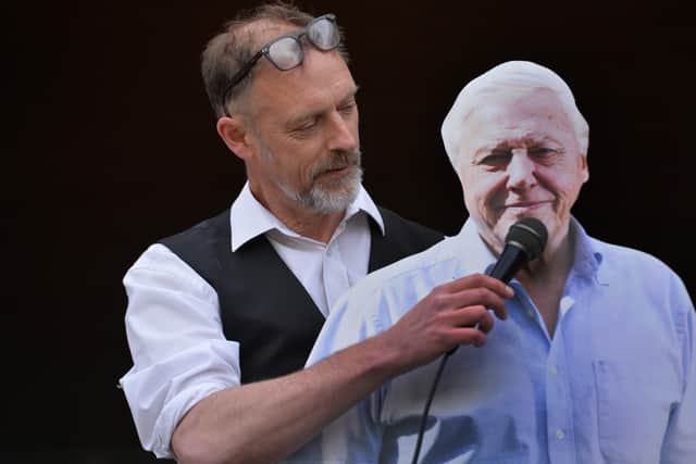 Adam Shipp with a cardboard cut-out of naturalist and environmentalist David Attenborough