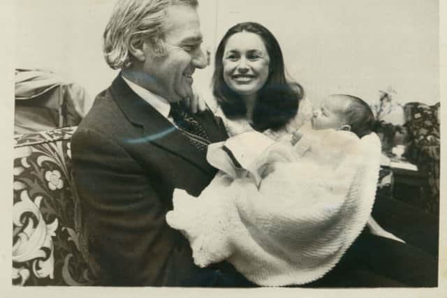 With his wife Barbara and newborn son James William John