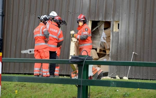 Emergency workers had to cut a hole in the side of the building to free the worker