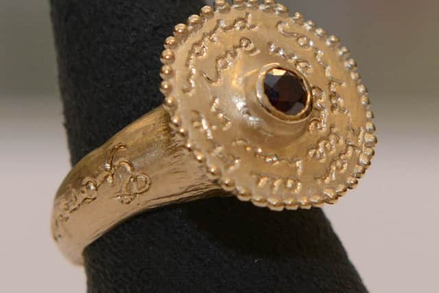 A close-up of the red diamond ring