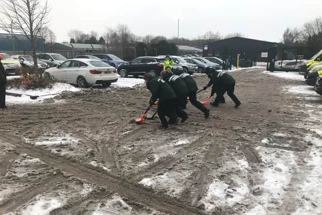 Paramedics, technicians and managers clear snow at Shrewsbury's ambulance hub