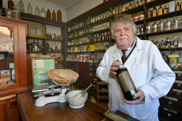 Andrew Homer who has written a book about Black Country Ghosts, pictured at work in the chemist shop at the Black Country Museum