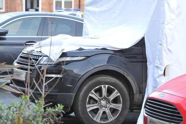 A police tent covering a Range Rover at the scene on Sunday morning