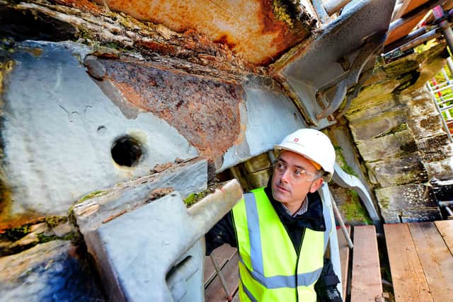 Damage to the top of the bridge with English Heritage's Head of conservation, Morgan Cowles