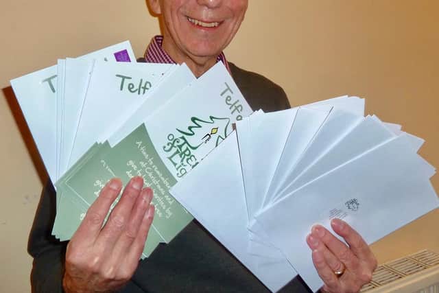 Rotarian Peter Seaward preparing Tree of Light details for posting