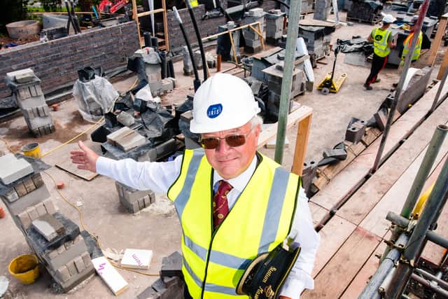 Chris Thomas Station Master stands among the ongoing construction work. 