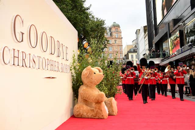 The Coldstream Guard brass band march past one of Merrythought's giant teddy bears