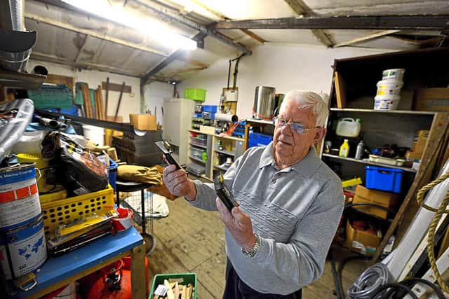 Mike Gatford looks at the bent locks from the storeroom door