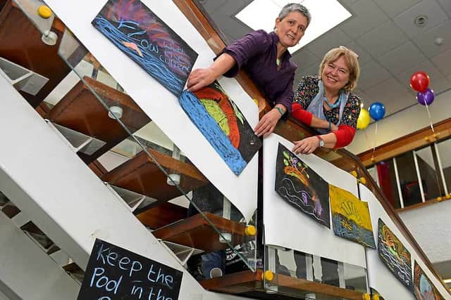 Ruth Gibson and Sue Challis hanging up the chalk pictures