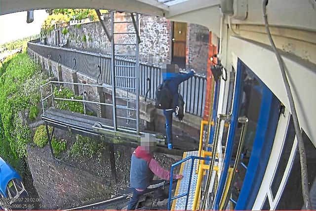 Two men clamber away from the carriage