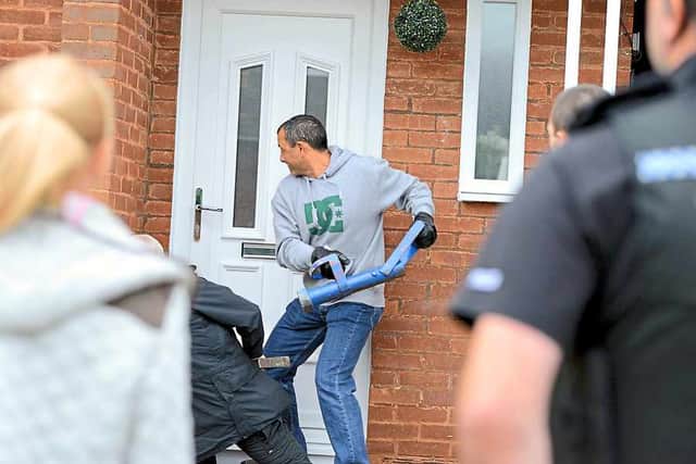 Police officers raid a property in Telford as the gangs year-long drugs conspiracy is brought to an end