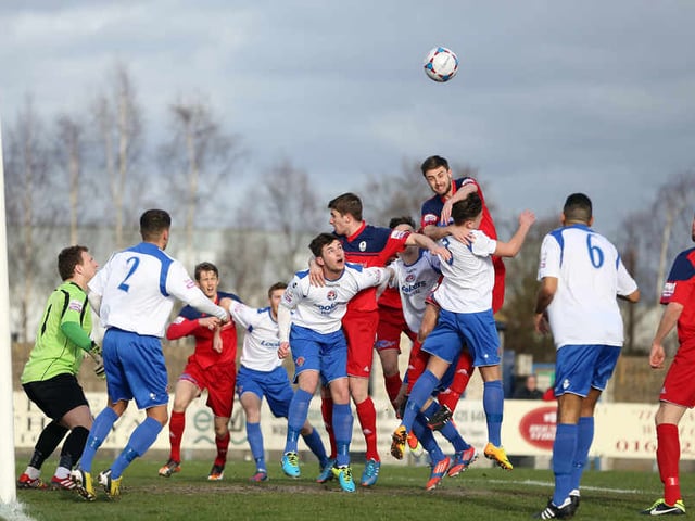 Chris Lever of AFC Telford United challenges for the ball from this Telford corner