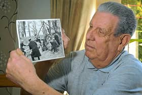 Frank with the picture of the rescue operation in progress