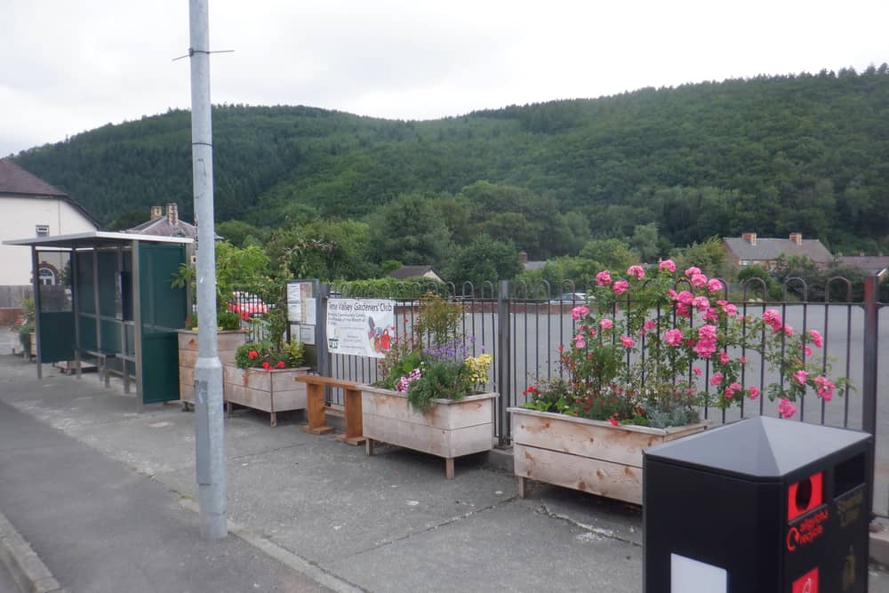 Knighton's Bowling Green Lane bus stop after the council replaced the ugly shelter and put in the flower planters. 
