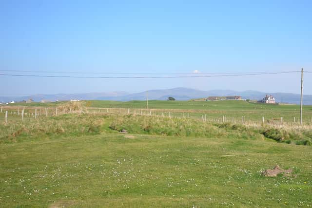 The rear view across fields to distant mountains from Wigwam