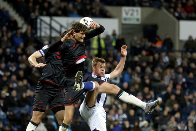 WEST BROMWICH, ENGLAND - APRIL 10: Caleb Taylor of Millwall appears to use his arm to move the ball as Aune Heggebo of West Bromwich Albion attempts to meet the cross and head at goal during the Sky Bet Championship match between West Bromwich Albion and Millwall at The Hawthorns on April 10, 2026 in West Bromwich, United Kingdom. (Photo by Adam Fradgley/West Bromwich Albion FC via Getty Images)