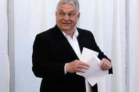 Viktor Orban puts his vote in an envelope