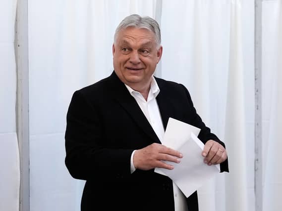 Viktor Orban puts his vote in an envelope