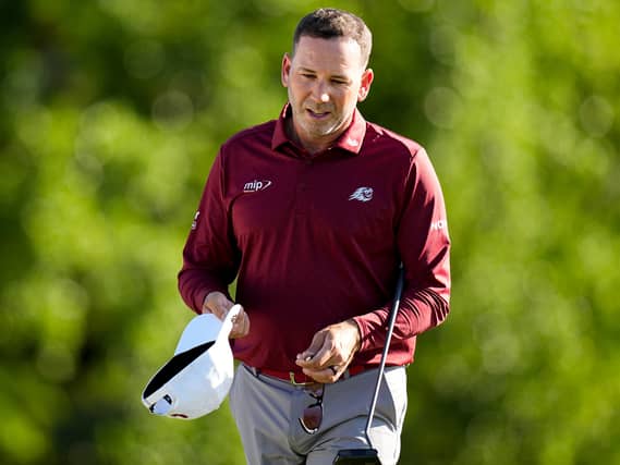 Sergio Garcia carries his cap and putter
