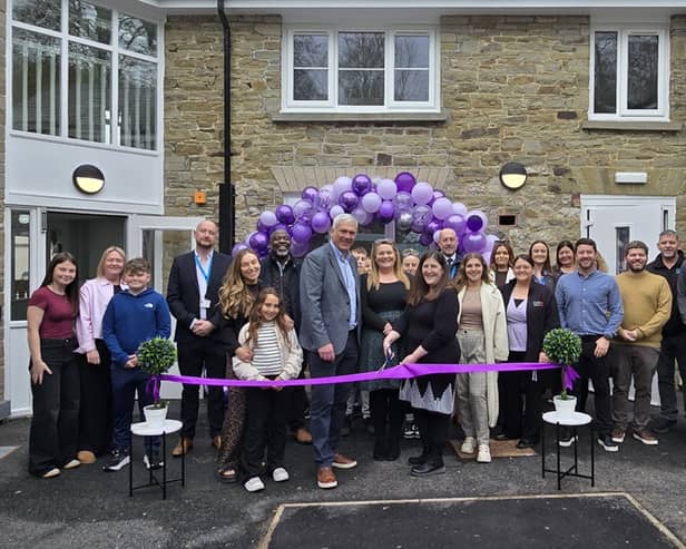 Andy Cresswell, CEO of Orbis Education and Care, and Hilary Jones, Head of Service, Additional Needs at Herefordshire Council, officially opening The Meadows surrounded by staff and parents