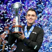 Ronnie O’Sullivan lifts the UK Championship trophy as confetti falls