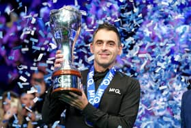 Ronnie O’Sullivan lifts the UK Championship trophy as confetti falls