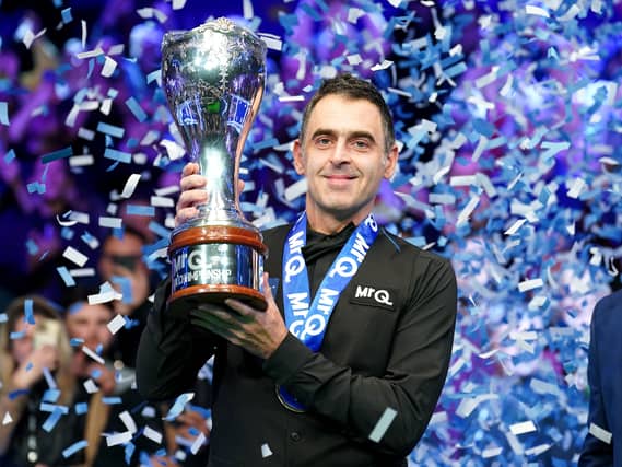 Ronnie O’Sullivan lifts the UK Championship trophy as confetti falls