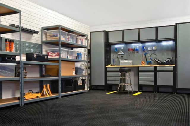 A complete BiGDUG garage setup showing how shelving, cabinets and a workbench can transform a cluttered space into a practical workshop