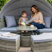 A stylish rattan garden day bed set with canopy and table creates the perfect spot for relaxing outdoors