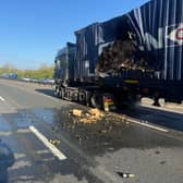 Smashed bottles of prosecco and a damaged truck on a motorway