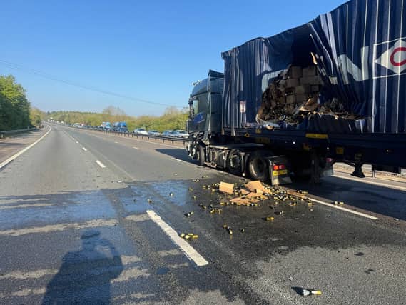 Smashed bottles of prosecco and a damaged truck on a motorway