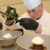 Calum Smith working on dishes.