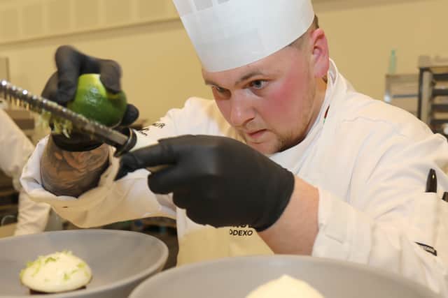 Calum Smith working on dishes.