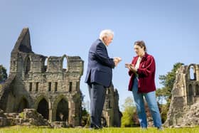 Simon White handed over the tiles to Assistant Curator Matty Cambridge at Wenlock Priory.