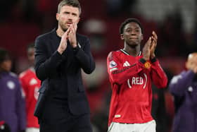 Manchester United head coach Michael Carrick and Kobbie Mainoo applaud