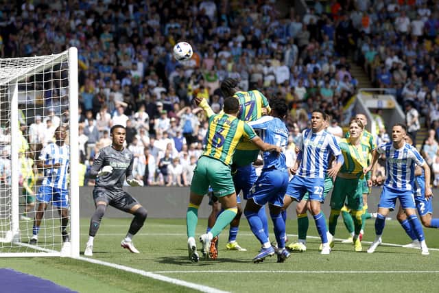 Ousmane Diakite heads well over for Albion in the first half.