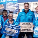 Russell Findlay standing in the middle of a crowd of Scottish Conservatives campaigners holding a placard that reads: 'use your peach vote to stop an SNP majority'