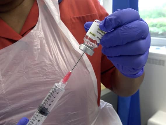 Close-up of a nurse preparing a new one-minute injection for more than a dozen cancers