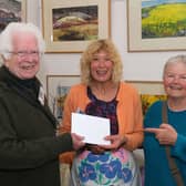  Artist Kathryn Moore being told she had won this year's Christine Forrester Award for the best exhibit at the festival by Kington Town Councillor, judge and partner of the late Christine, Bob Widdowson and Annie Vickerstaff, also a member of the judging panel