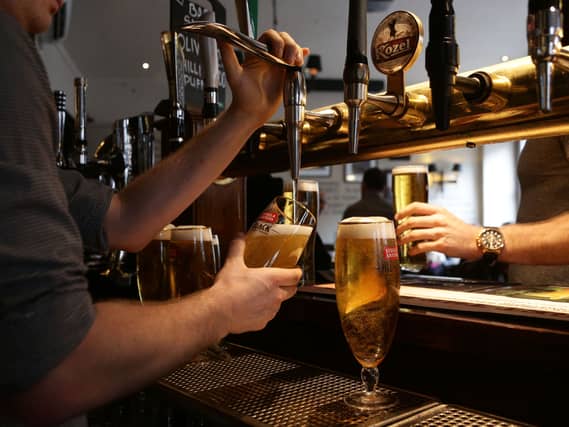 A barman pouring drinks