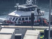 A group of people thought to be migrants are brought in to the Border Security Command compound in Dover
