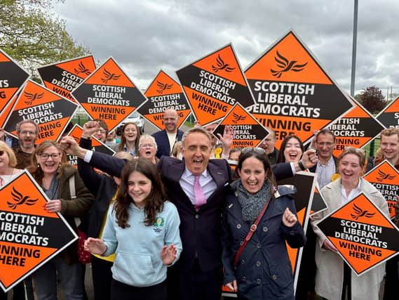 Alex Cole-Hamilton with his wife Gill and daughter Darcy surrounded by supporters