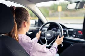 A young woman driving a car