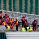 A group of people thought to be migrants are brought in to the Border Force compound in Dover