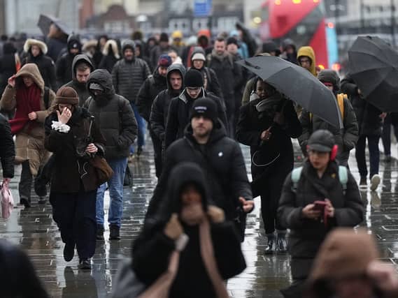 Commuters battle with the wintry conditions on London Bridge