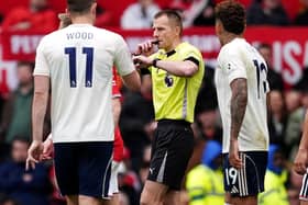 Referee Michael Salisbury (centre) on the pitch