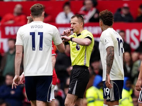 Referee Michael Salisbury (centre) on the pitch