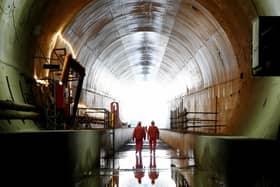 Members of HS2 staff walk through the Chilterns tunnel towards the tunnel exit at West Hyde, Hertfordshire, as the HS2 project continues