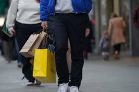 Someone laden with bags of shopping